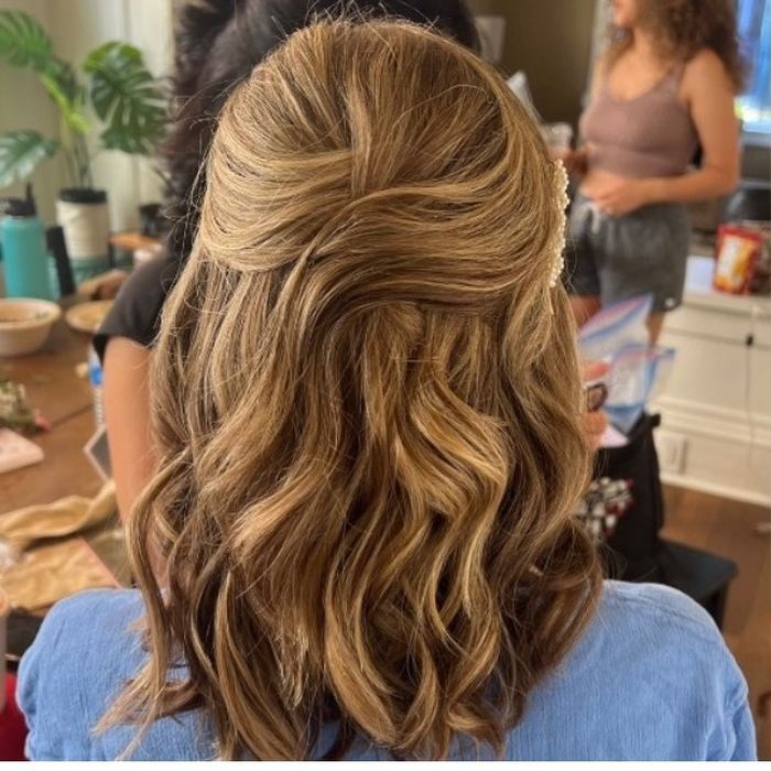 Half-up hairstyle with a jeweled hair clip, mobile styling